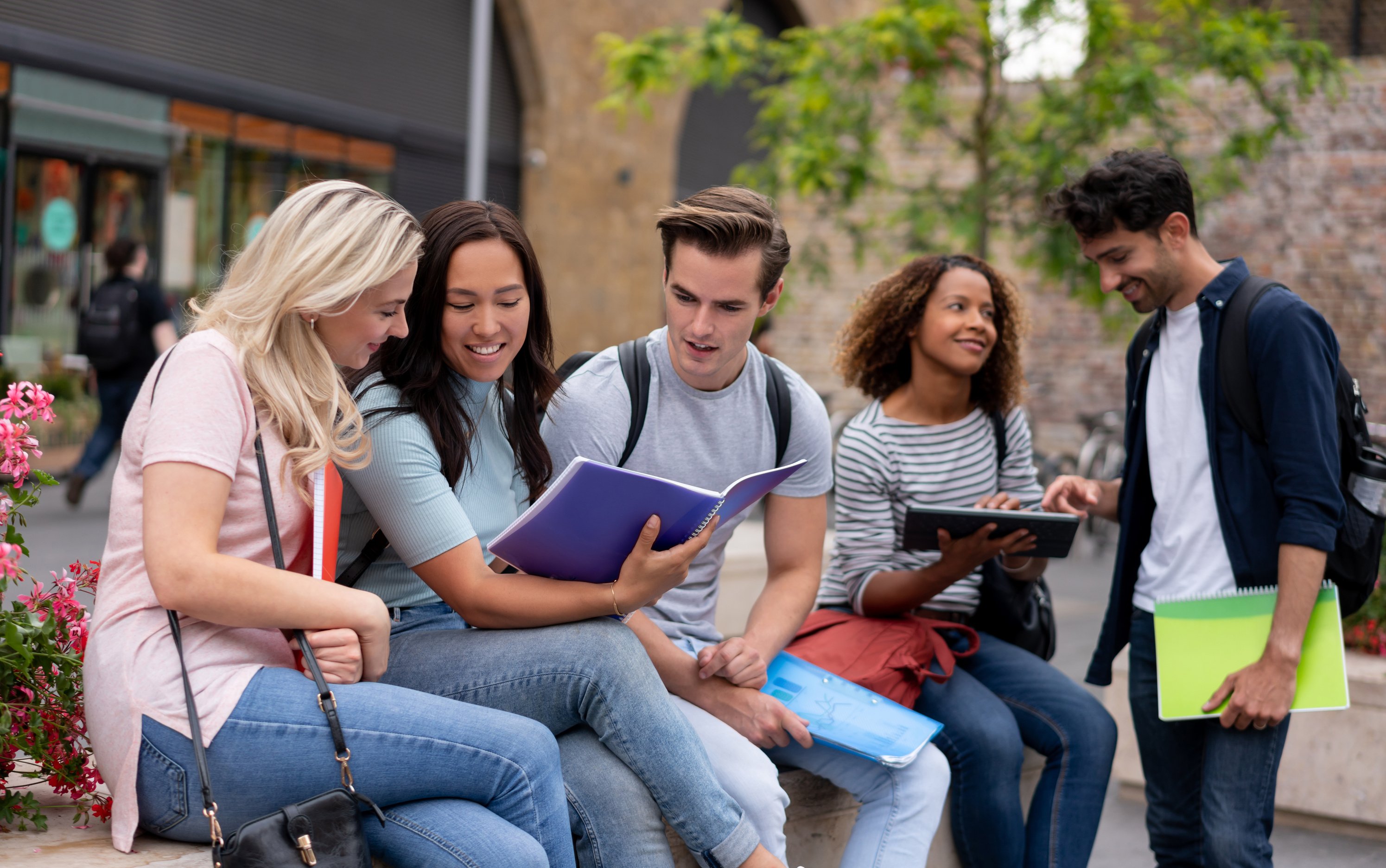 Happy group of students studying abroad in London