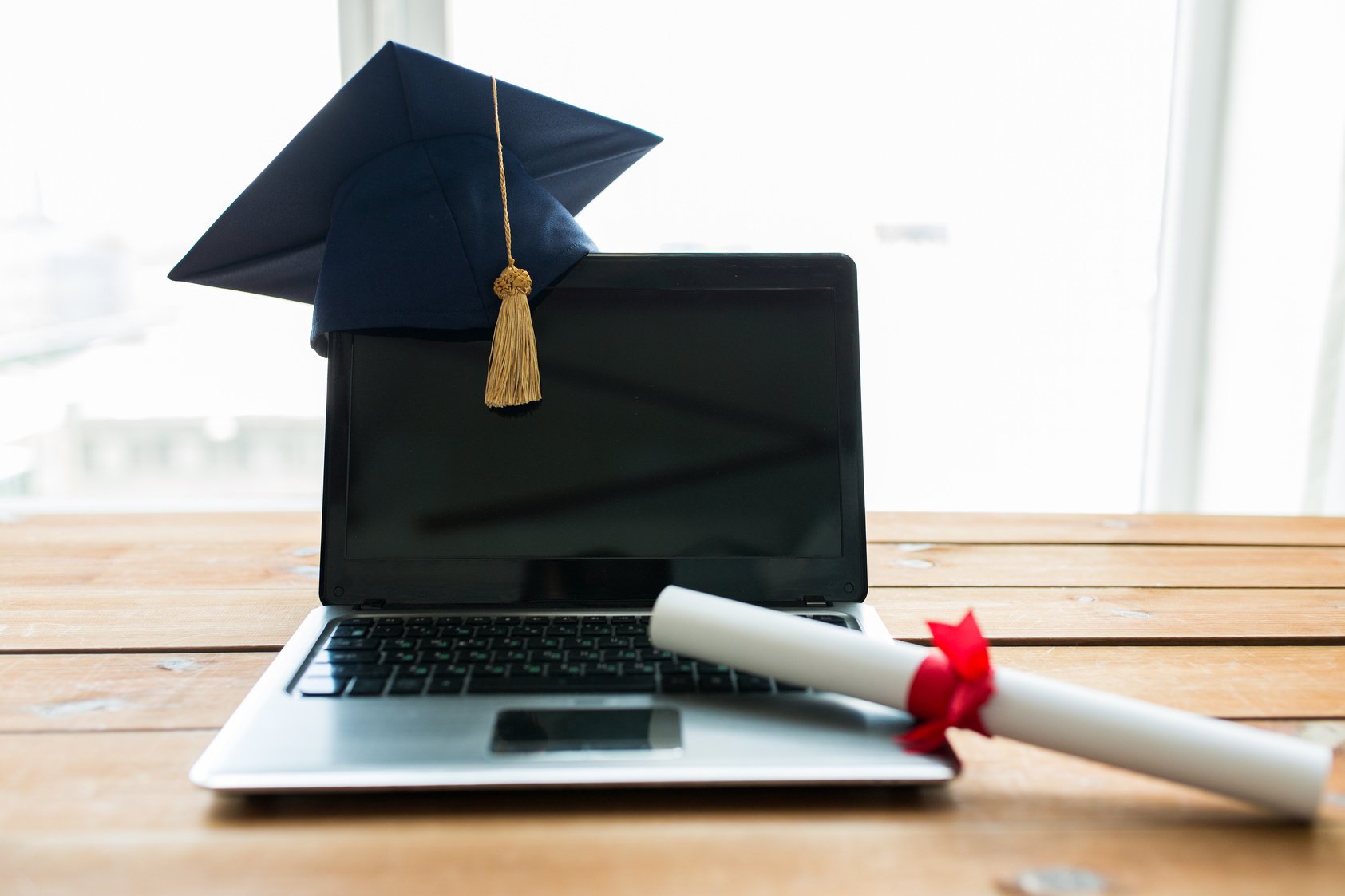 Laptop with Mortarboard and Diploma